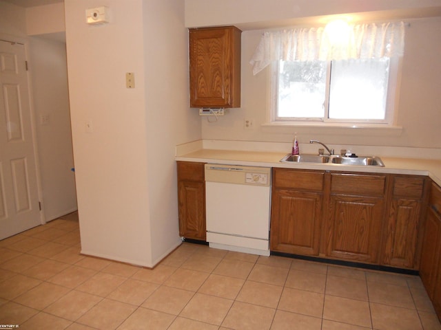 kitchen featuring sink, dishwasher, and light tile patterned floors