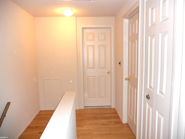 corridor with light wood-type flooring