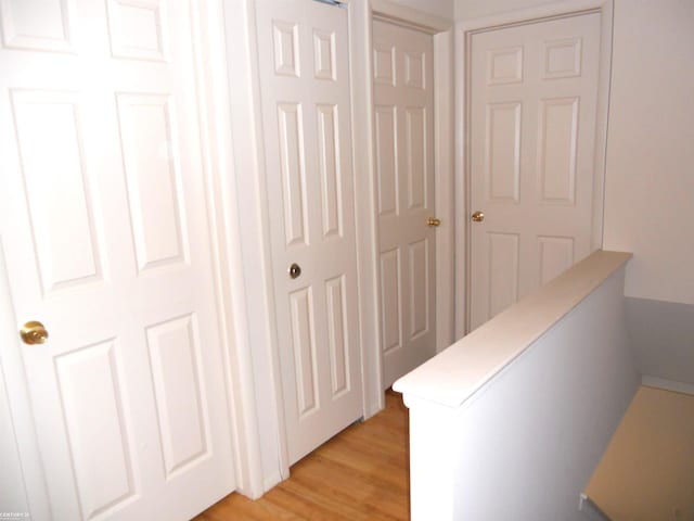 corridor with light wood-type flooring