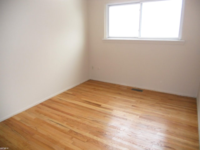 unfurnished room with light hardwood / wood-style floors