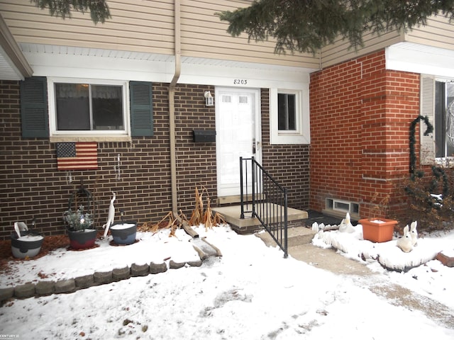 view of snow covered property entrance