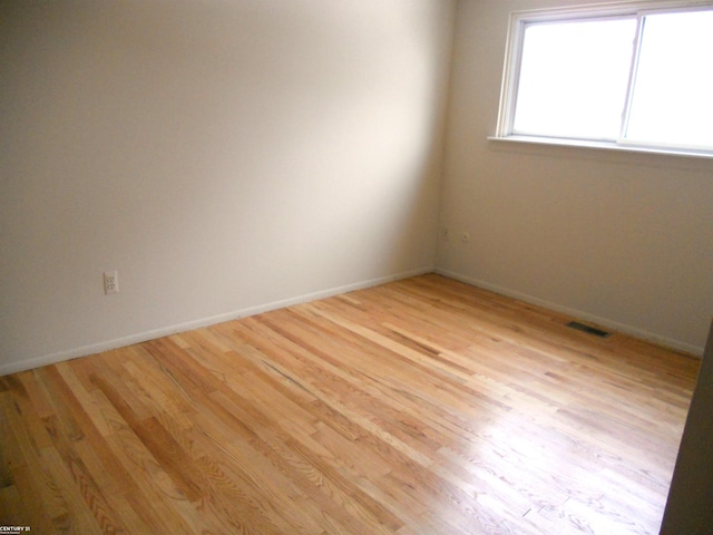 spare room featuring light hardwood / wood-style flooring