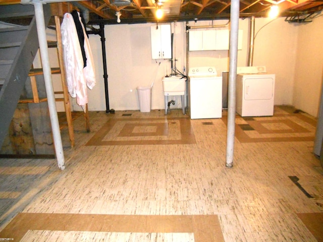 basement with separate washer and dryer and sink