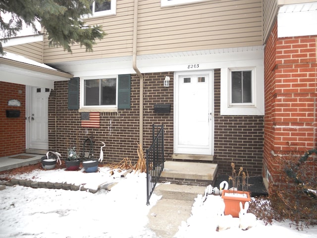 view of snow covered property entrance