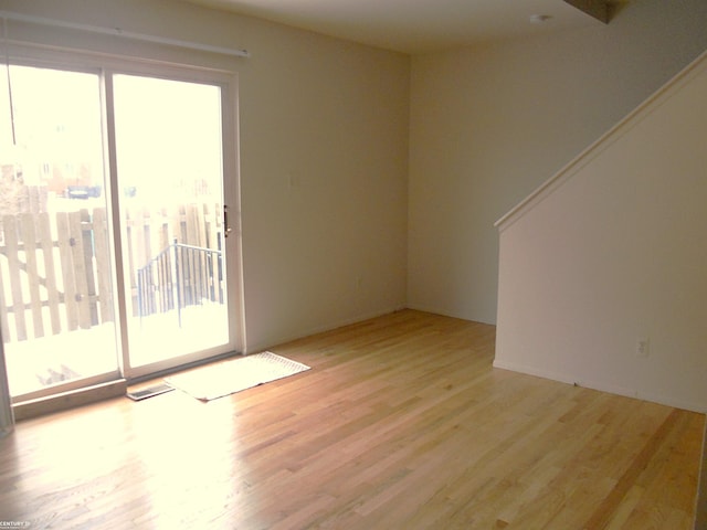 unfurnished room with light hardwood / wood-style floors and a healthy amount of sunlight