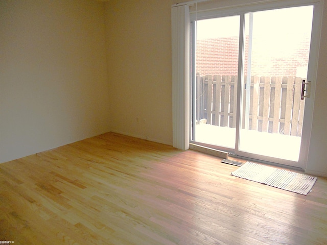 empty room with light hardwood / wood-style floors