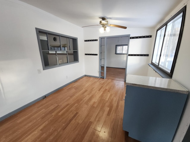 unfurnished living room featuring ceiling fan and wood-type flooring