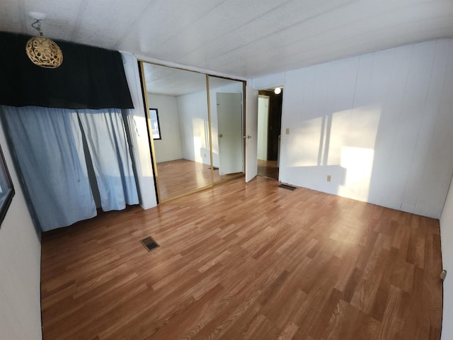 unfurnished room with hardwood / wood-style flooring