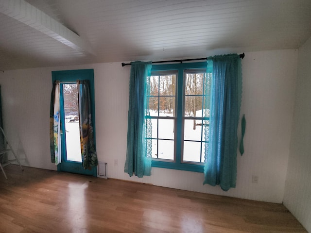 unfurnished room with hardwood / wood-style flooring