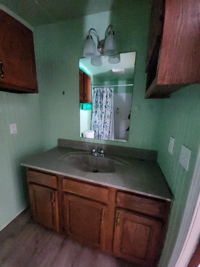 bathroom with walk in shower, vanity, toilet, and hardwood / wood-style flooring