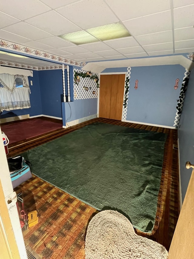 game room featuring a paneled ceiling and carpet flooring