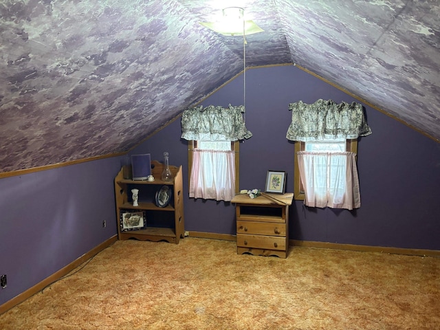 additional living space with vaulted ceiling, a healthy amount of sunlight, and carpet