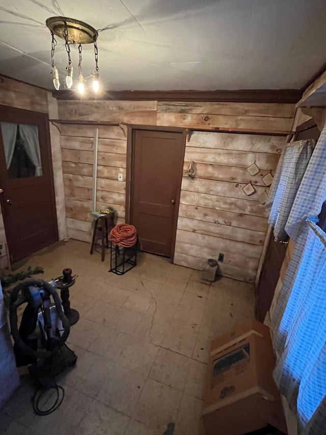 unfurnished dining area featuring wooden walls