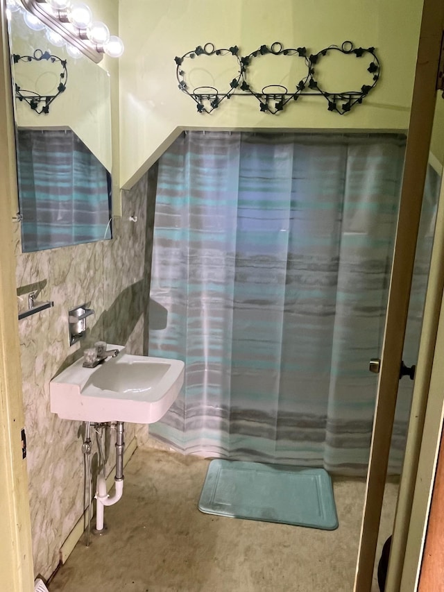 bathroom featuring walk in shower and sink