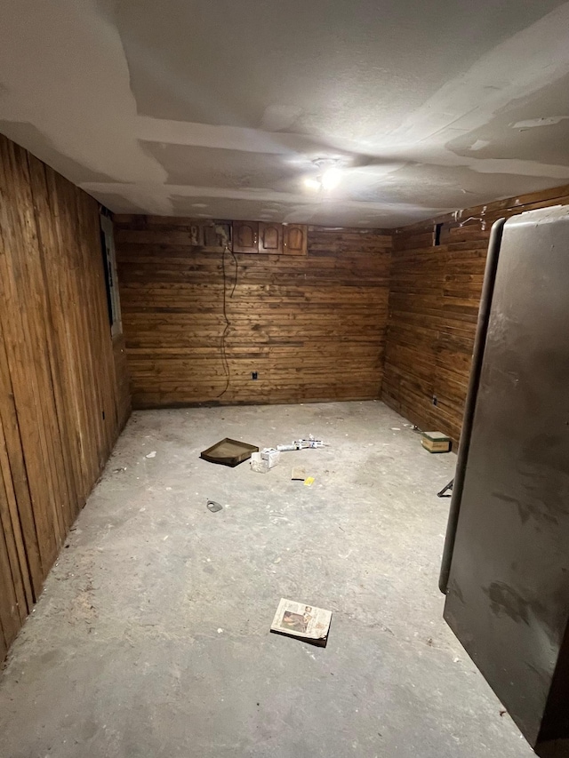 basement featuring wooden walls