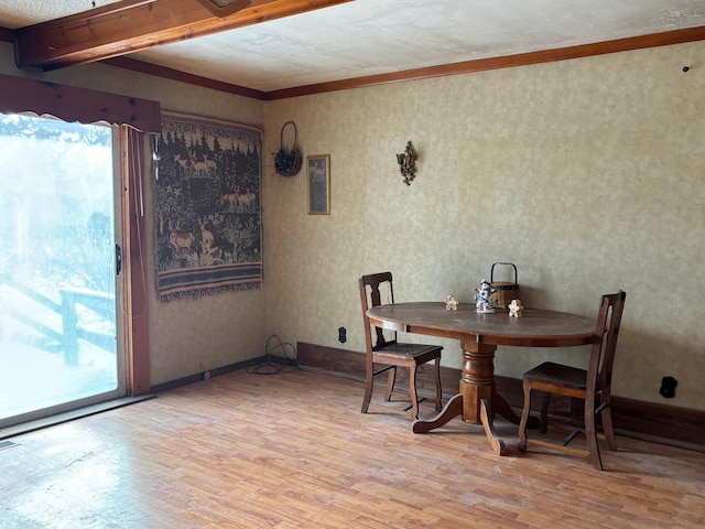 dining space featuring light hardwood / wood-style flooring, crown molding, and beamed ceiling