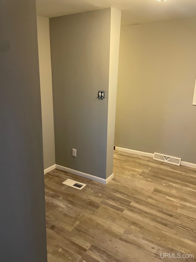 empty room with hardwood / wood-style floors