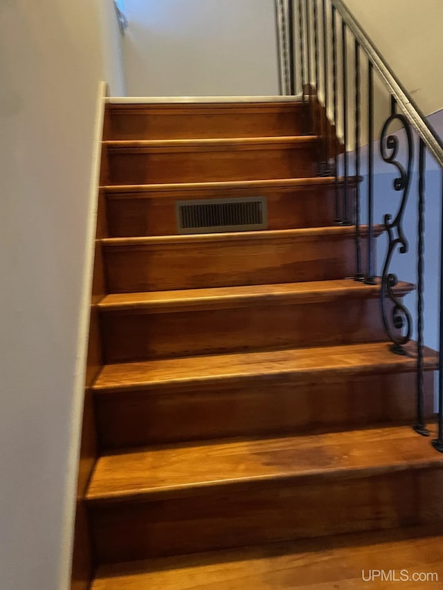 stairway featuring wood-type flooring