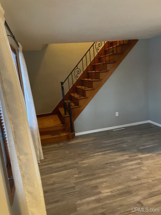 stairway with hardwood / wood-style flooring