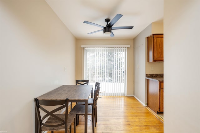 dining space featuring ceiling fan and light wood-type flooring