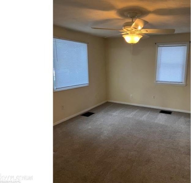 carpeted empty room featuring ceiling fan