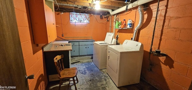 laundry area featuring washing machine and dryer and cabinets