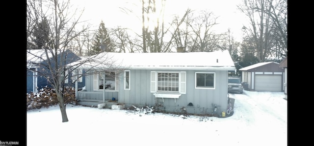 view of front of house with a garage and an outdoor structure