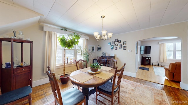 dining space with a notable chandelier and hardwood / wood-style floors