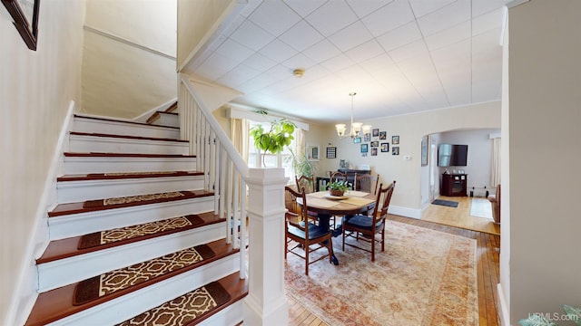 dining area with light hardwood / wood-style floors and a chandelier