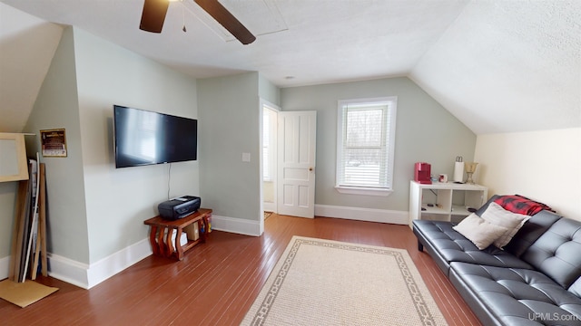 living room featuring ceiling fan, vaulted ceiling, and hardwood / wood-style flooring