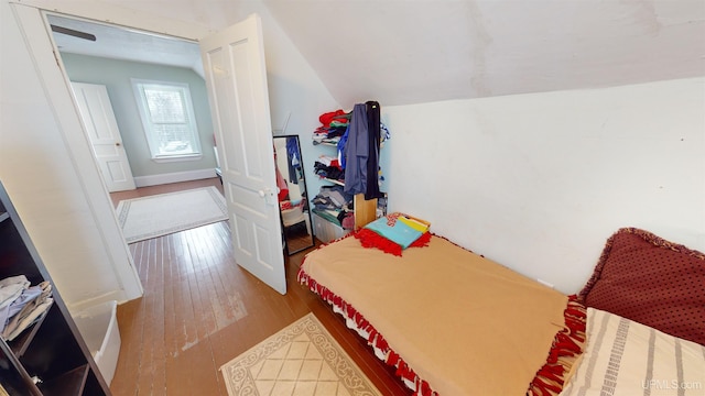 bedroom featuring hardwood / wood-style floors and vaulted ceiling