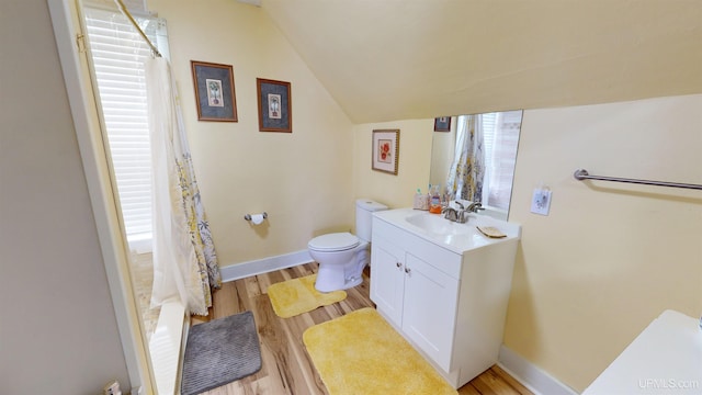 full bathroom with shower / bath combination with curtain, toilet, vanity, hardwood / wood-style flooring, and lofted ceiling