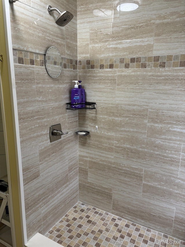 bathroom with a tile shower