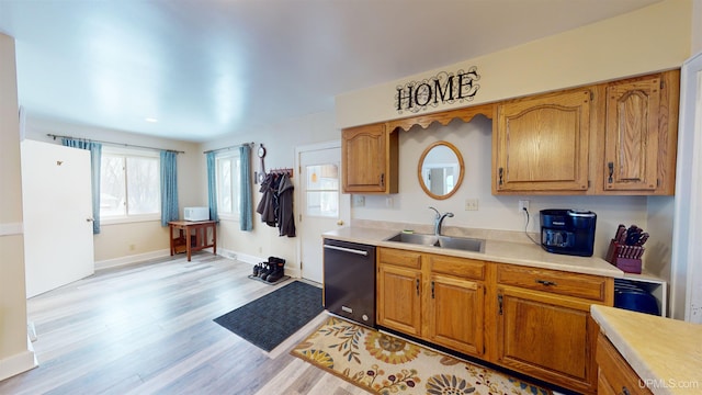 kitchen featuring sink, light hardwood / wood-style floors, and dishwasher