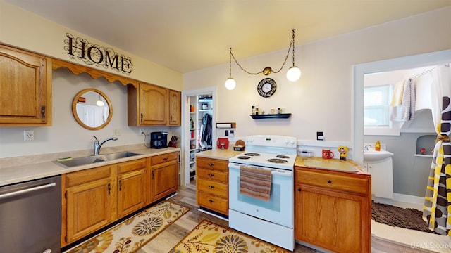 kitchen featuring dishwasher, light hardwood / wood-style flooring, hanging light fixtures, white range with electric cooktop, and sink