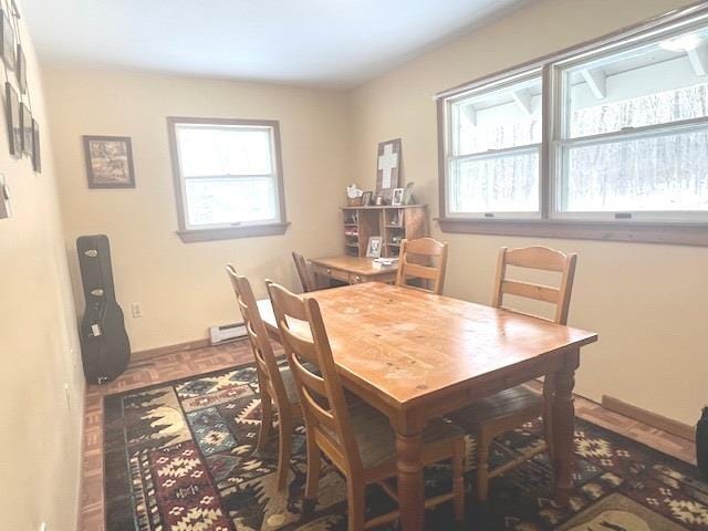 dining area featuring parquet floors and a baseboard heating unit