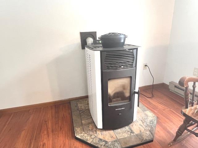 details with a baseboard heating unit and wood-type flooring