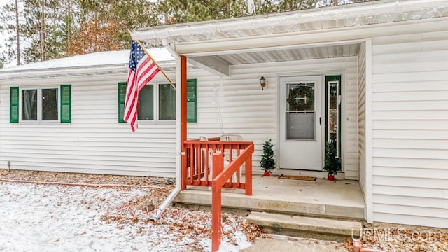 view of snow covered property entrance