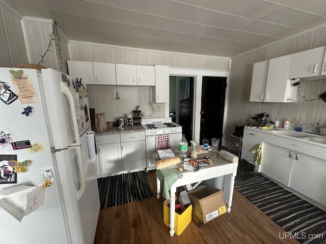 kitchen with white appliances, dark wood-type flooring, white cabinets, and sink