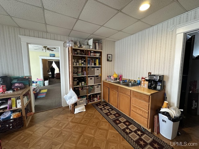 office featuring ceiling fan, sink, and light parquet flooring