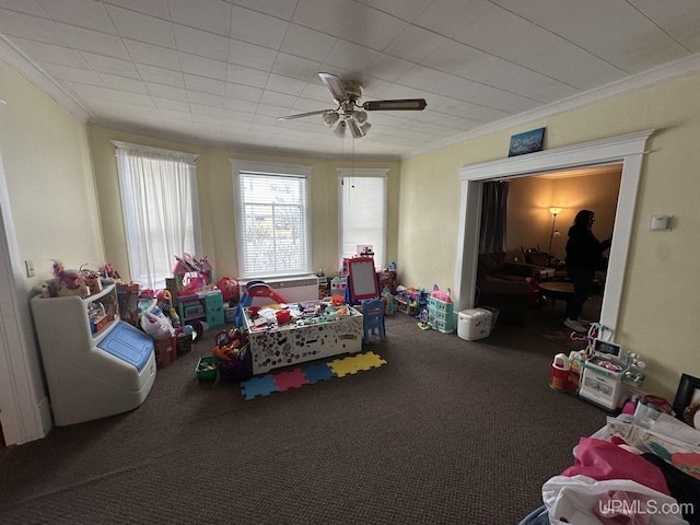 rec room featuring ceiling fan, carpet, and crown molding