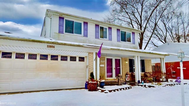 view of front of property featuring covered porch and a garage