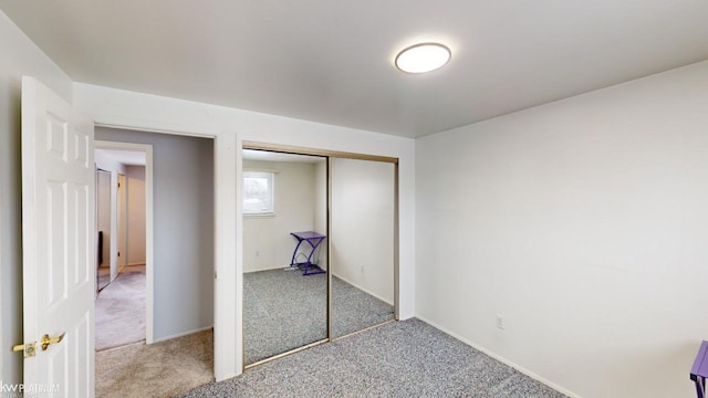 unfurnished bedroom with a closet and carpet floors