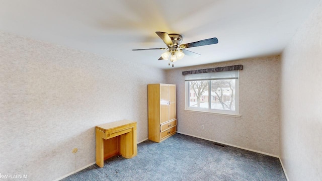 unfurnished bedroom with ceiling fan and carpet flooring