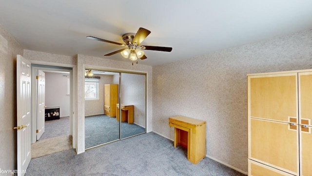 unfurnished bedroom featuring light colored carpet, ceiling fan, and a closet