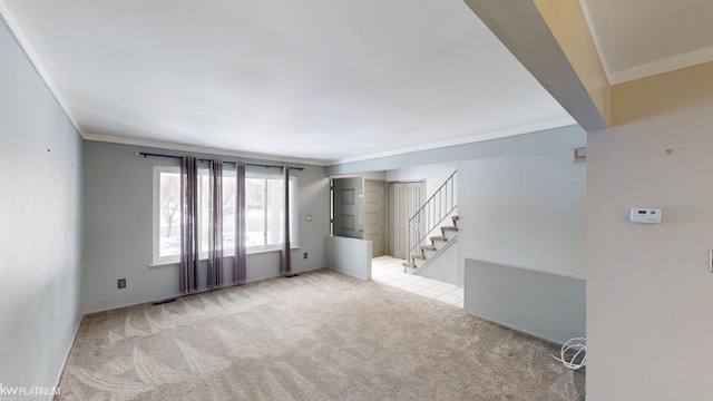 interior space featuring ornamental molding and light colored carpet