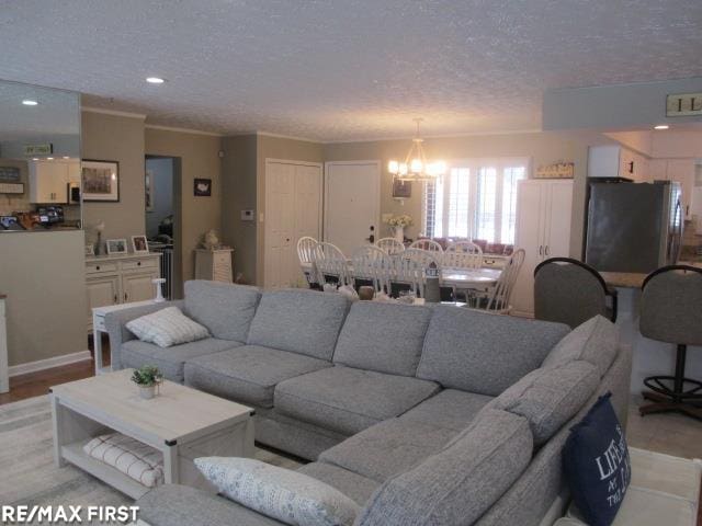 living room with a textured ceiling and a chandelier