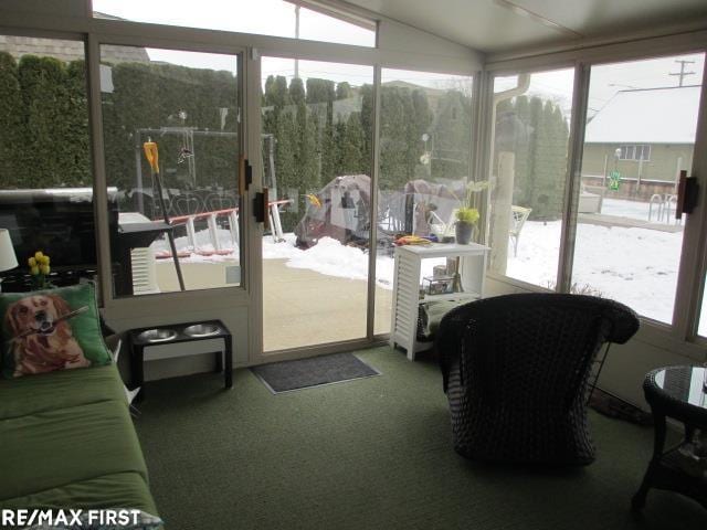 sunroom featuring vaulted ceiling