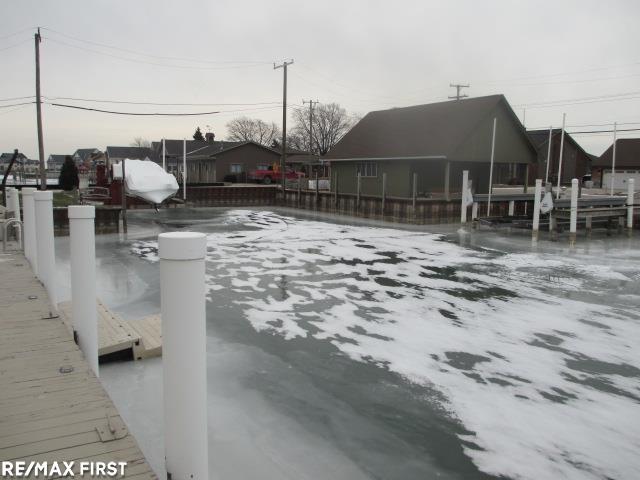 yard layered in snow featuring a dock