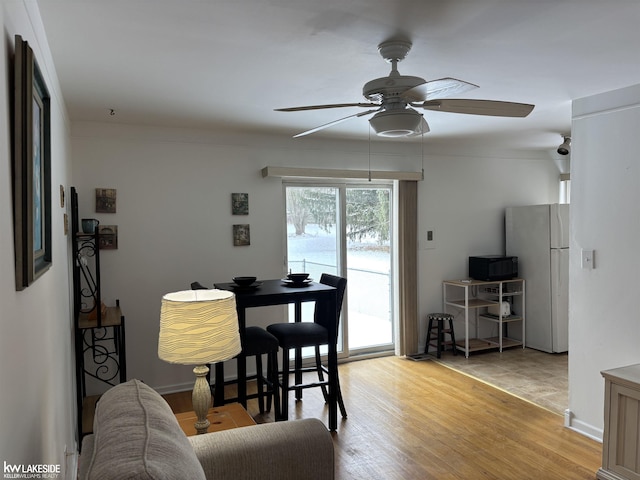 dining space featuring ceiling fan and light hardwood / wood-style flooring